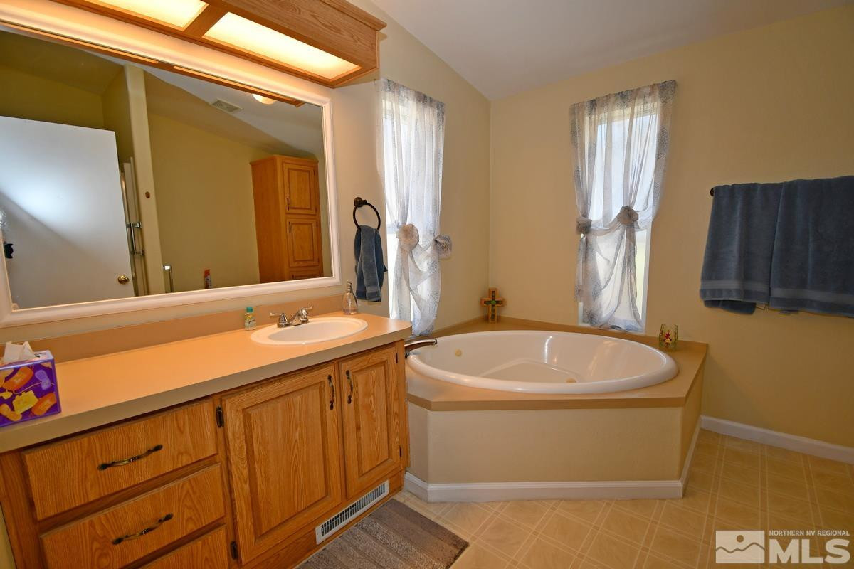 229 Mark Street Gardnerville, NV 89410 - Photo 11 of 24 a bathroom with a sink a toilet and mirror