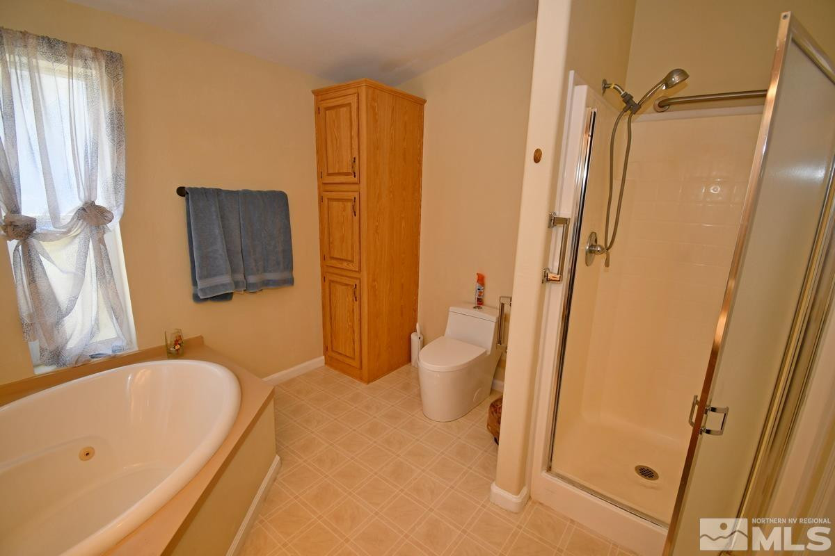 229 Mark Street Gardnerville, NV 89410 - Photo 12 of 24 a bathroom with a tub sink and mirror