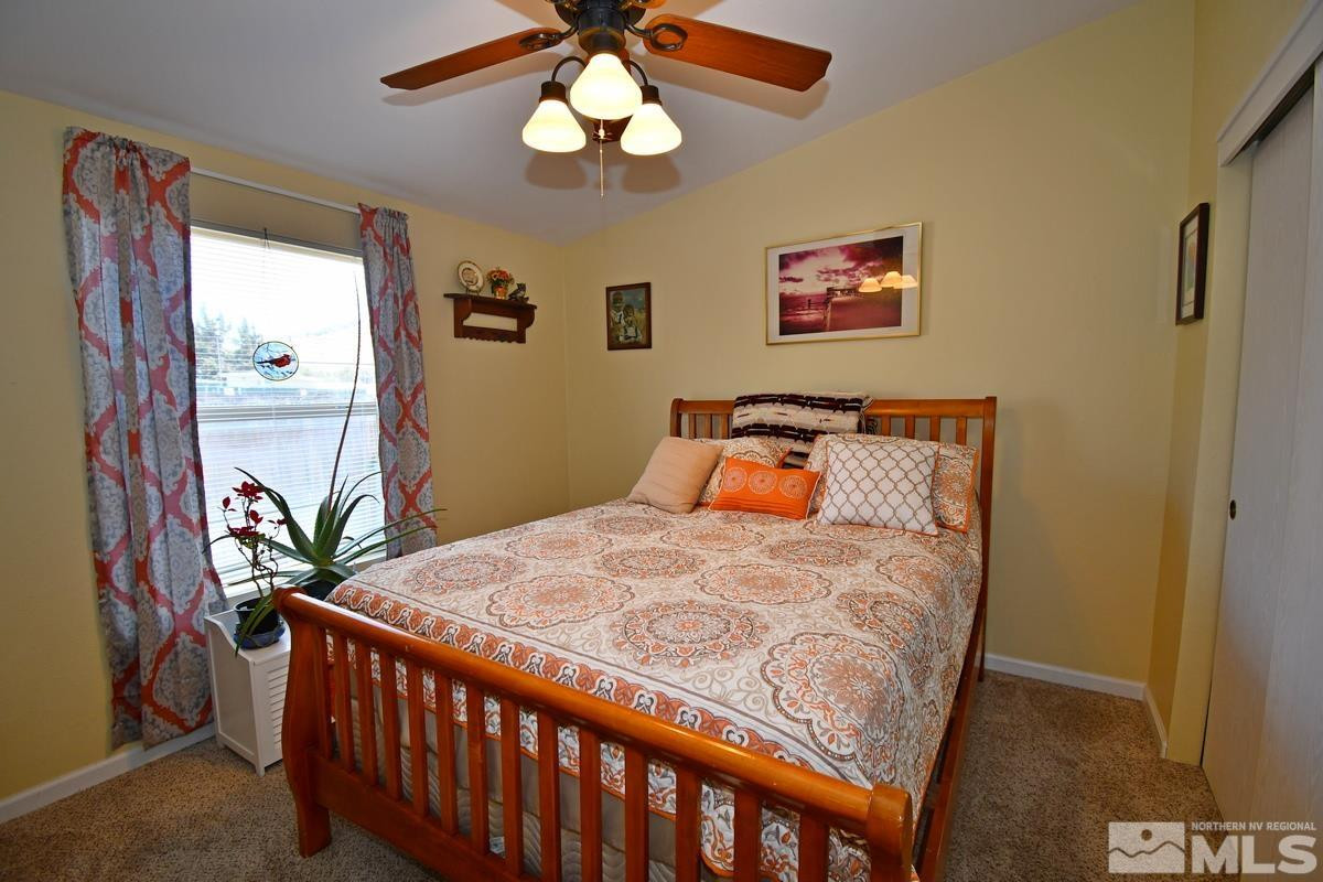 229 Mark Street Gardnerville, NV 89410 - Photo 13 of 24 a bedroom with bed and wooden floor