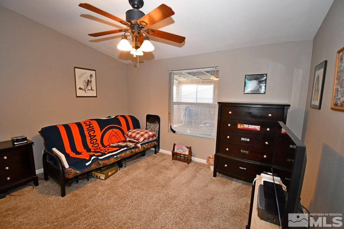 229 Mark Street Gardnerville, NV 89410 - Photo 15 of 24 a bedroom with a bed and a chandelier