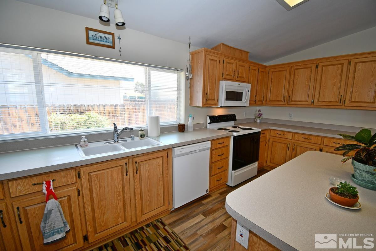 229 Mark Street Gardnerville, NV 89410 - Photo 2 of 24 a kitchen with wooden cabinets a sink and a stove