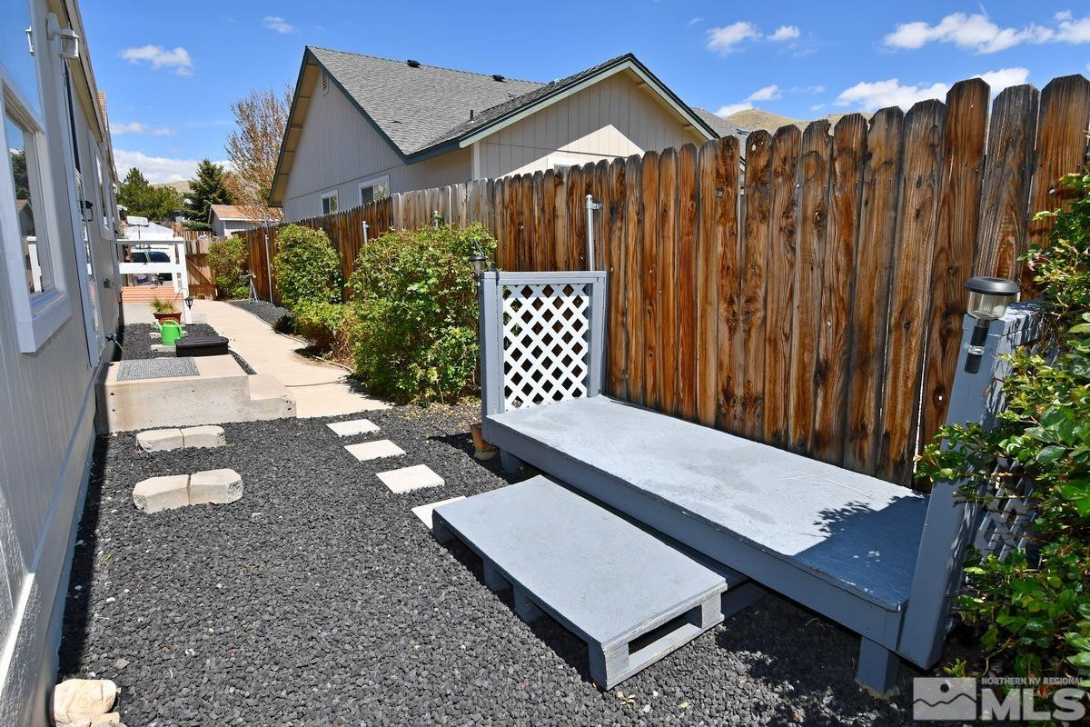 229 Mark Street Gardnerville, NV 89410 - Photo 21 of 24 a view of a wooden bench in front of a house