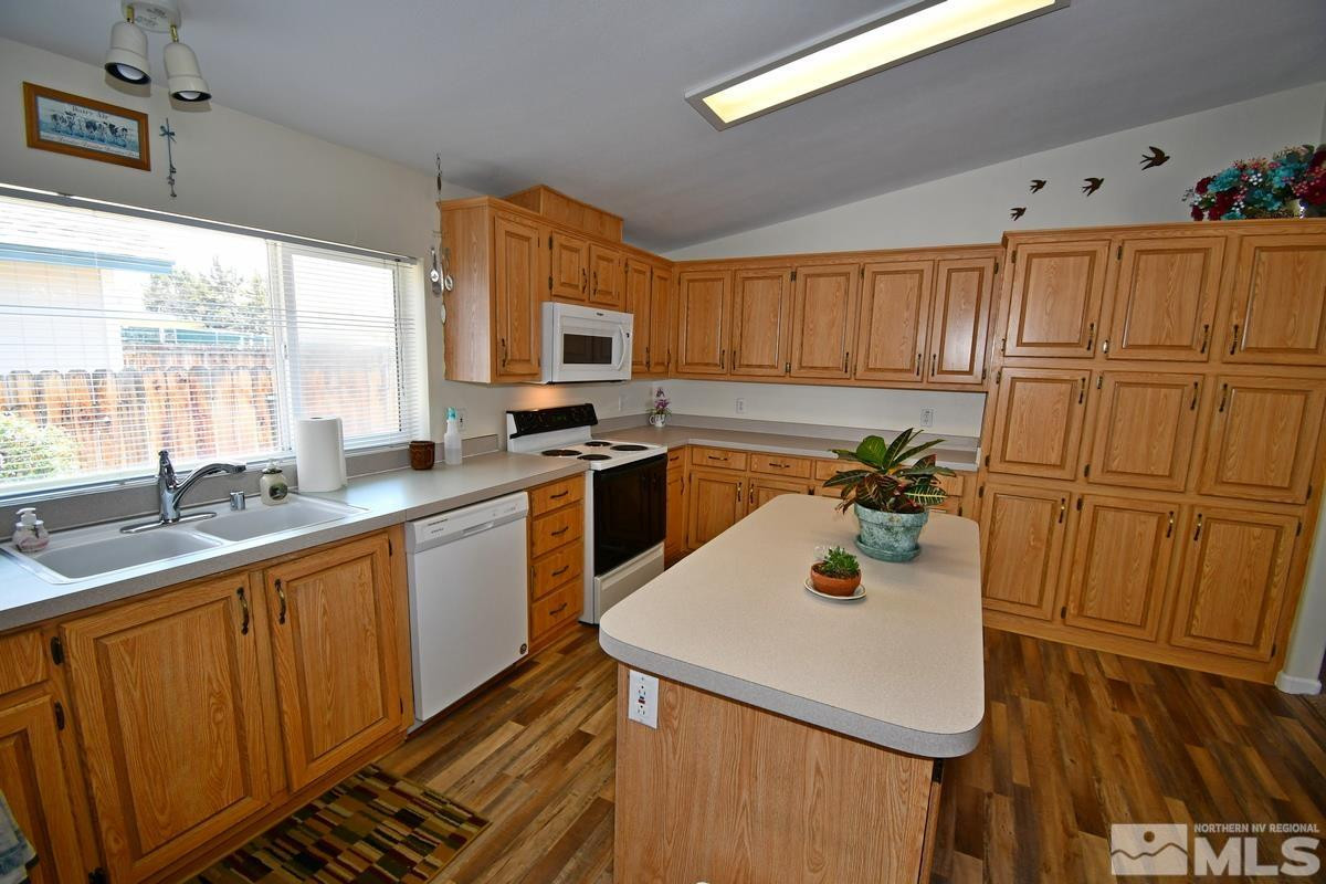 229 Mark Street Gardnerville, NV 89410 - Photo 3 of 24 a kitchen with stainless steel appliances a sink a stove and a refrigerator