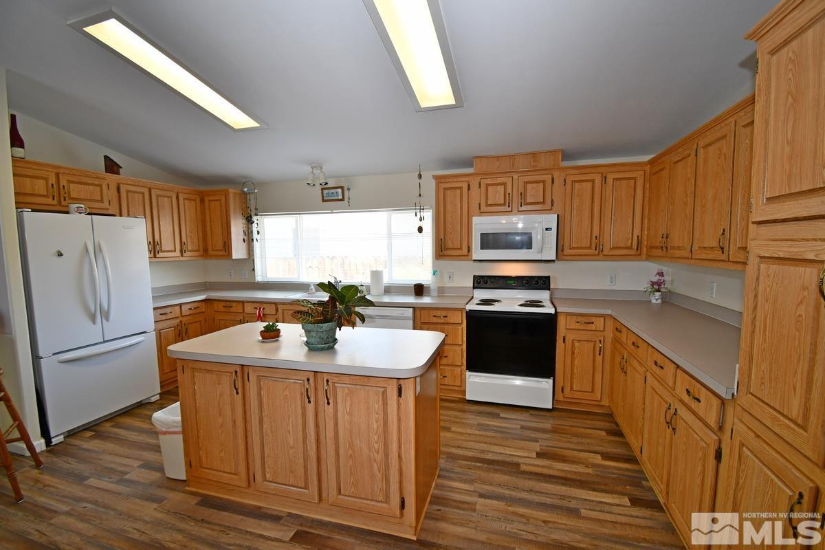 229 Mark Street Gardnerville, NV 89410 - Photo 4 of 24 a kitchen with a sink stove and refrigerator