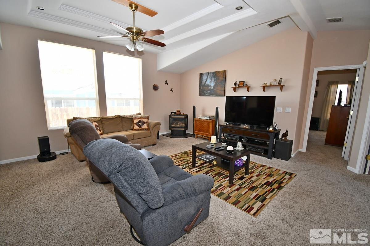 229 Mark Street Gardnerville, NV 89410 - Photo 8 of 24 a living room with furniture a flat screen tv and a large window