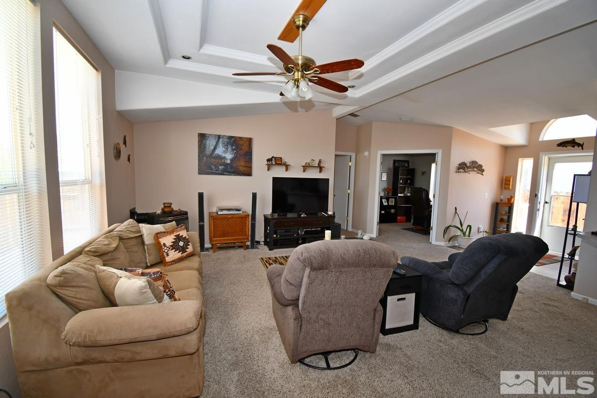 229 Mark Street Gardnerville, NV 89410 - Photo 9 of 24 a living room with furniture a fireplace and a window