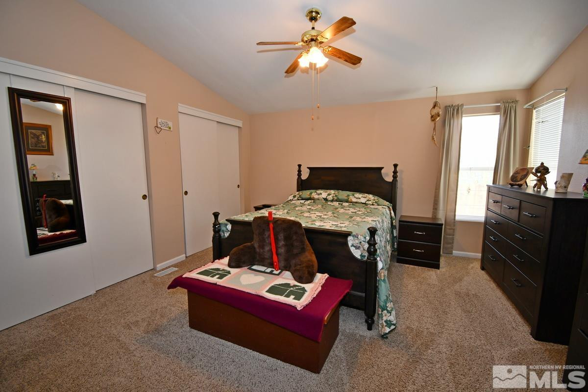 229 Mark Street Gardnerville, NV 89410 - Photo 10 of 24 a bedroom with a bed and a chandelier