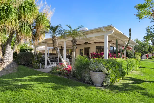 a view of a house with a backyard and a garden