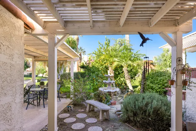 a view of a chair and table in backyard