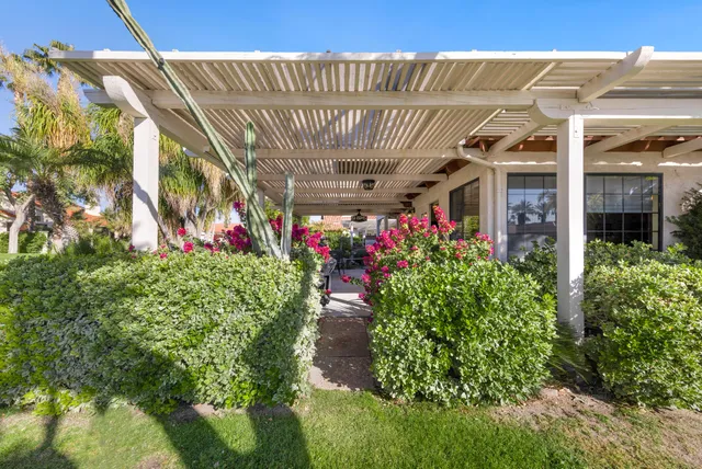 a view of a pathway with a flower garden