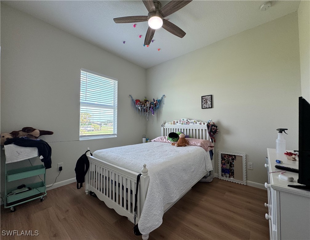 1818 Inwood Road LaBelle, FL 33935 - Photo 11 of 28 a bedroom with a bed and a tv