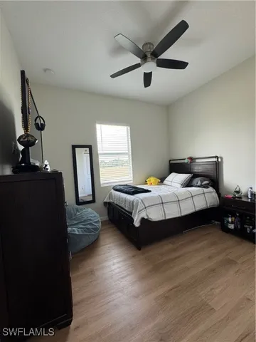 a bedroom with a bed couch and a window