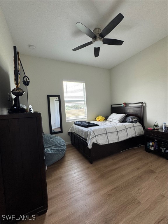 1818 Inwood Road LaBelle, FL 33935 - Photo 13 of 28 a bedroom with a bed couch and a window