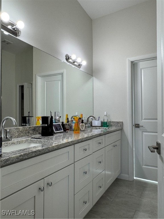 1818 Inwood Road LaBelle, FL 33935 - Photo 17 of 28 a bathroom with double sink and a mirror