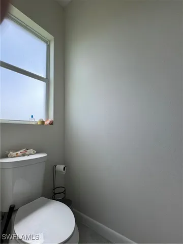 a white toilet sitting next to a bathroom sink