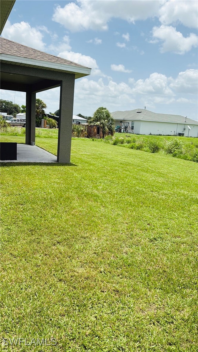 1818 Inwood Road LaBelle, FL 33935 - Photo 22 of 28 a view of a swimming pool and an outdoor seating