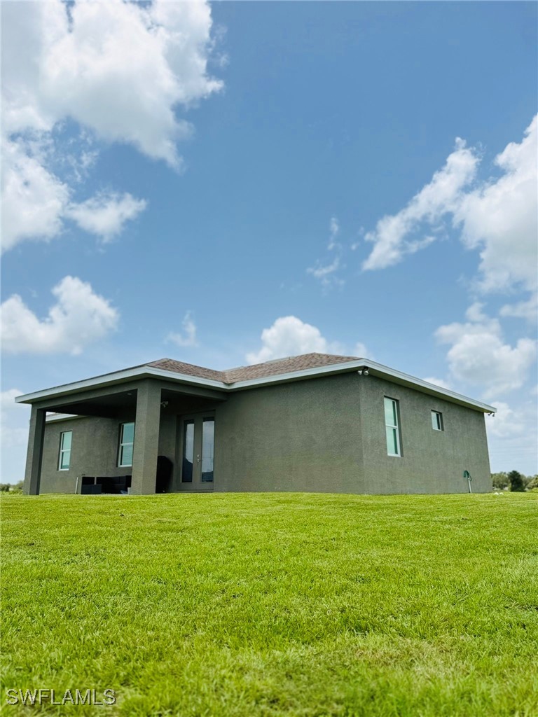 1818 Inwood Road LaBelle, FL 33935 - Photo 6 of 28 a front view of a house with a garden