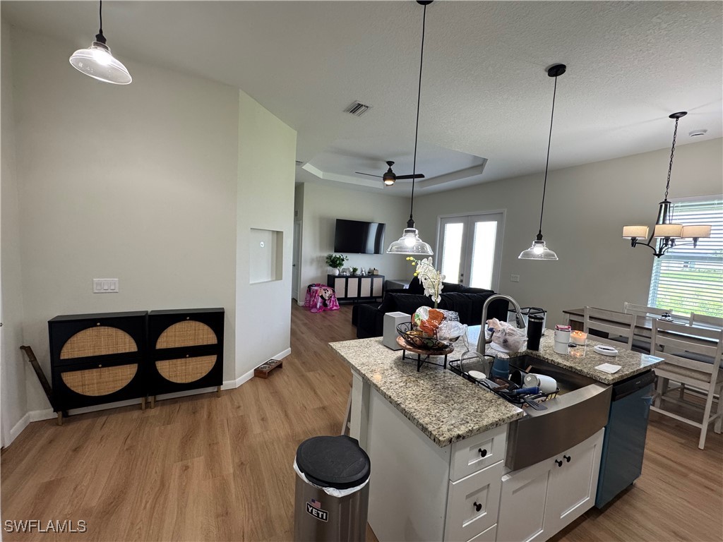 1818 Inwood Road LaBelle, FL 33935 - Photo 7 of 28 a kitchen with a stove and a wooden floor