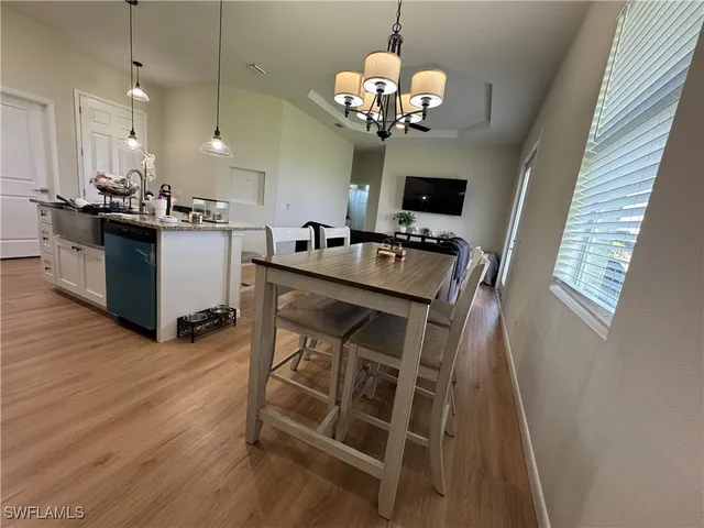 a view of a dining room with furniture wooden floor and chandelier