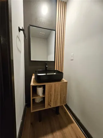 a room with wooden floor and furniture