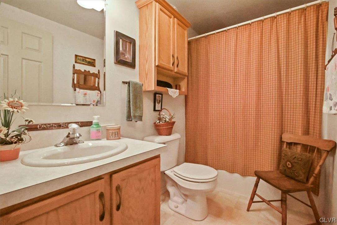 18 Abbey Road Easton, PA 18040 - Photo 18 of 30 a bathroom with a sink a toilet and shower curtain