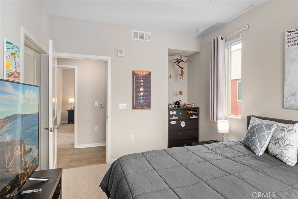 135 Bowery Irvine, CA 92612 - Photo 15 of 31 a bedroom with a bed and walk in closet