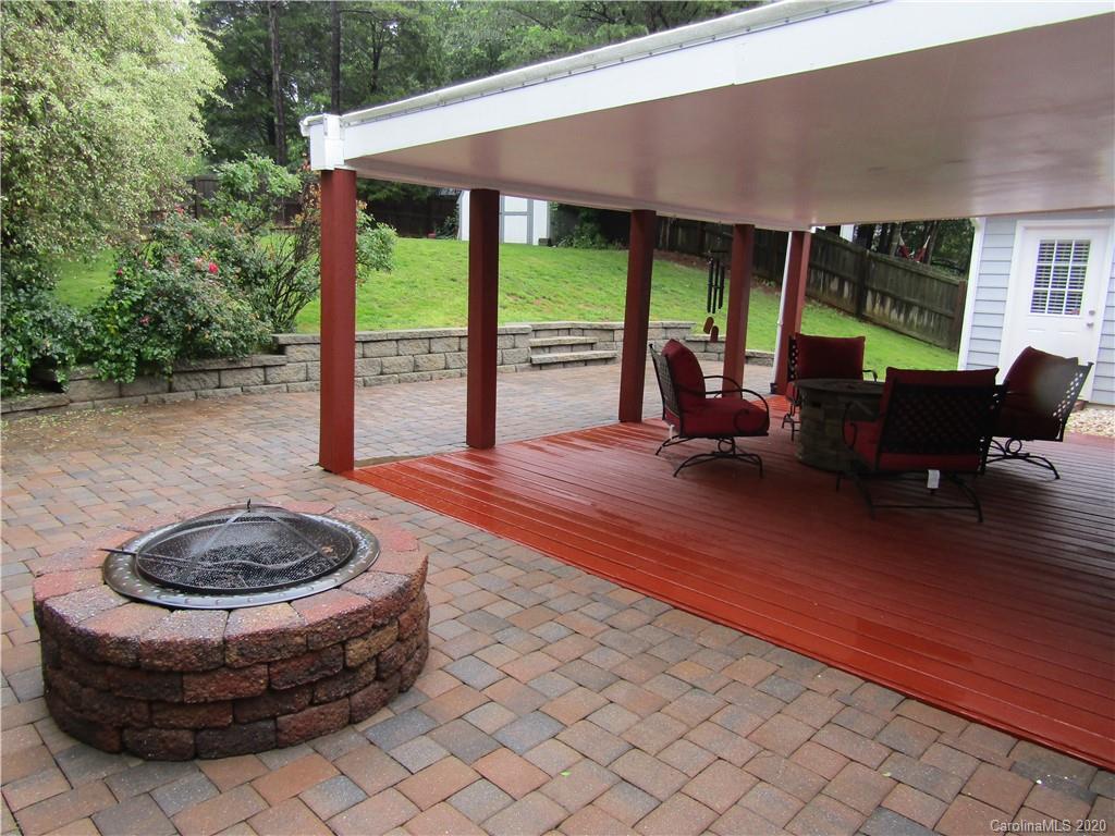 12820 Danby Road Indian Land, SC 29707 - Photo 19 of 21 a view of a patio with table and chairs potted plants with wooden floor and fence