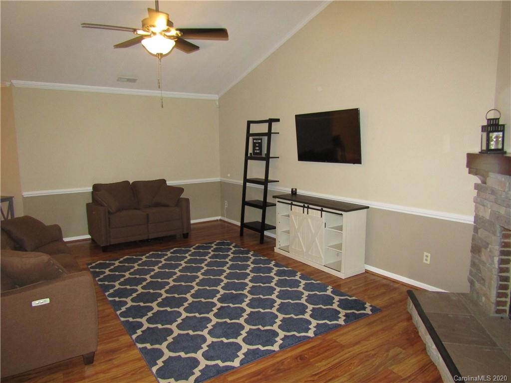 12820 Danby Road Indian Land, SC 29707 - Photo 4 of 21 a living room with a rug and a flat screen tv