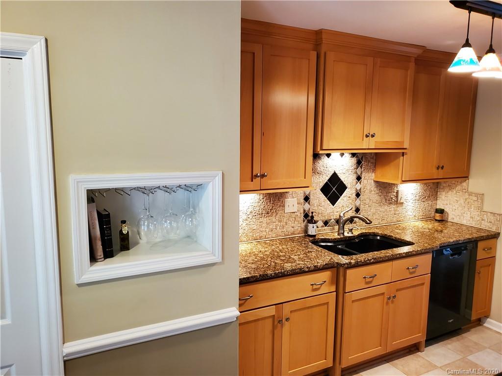 12820 Danby Road Indian Land, SC 29707 - Photo 5 of 21 a kitchen with stainless steel appliances granite countertop a sink and cabinets with wooden floor