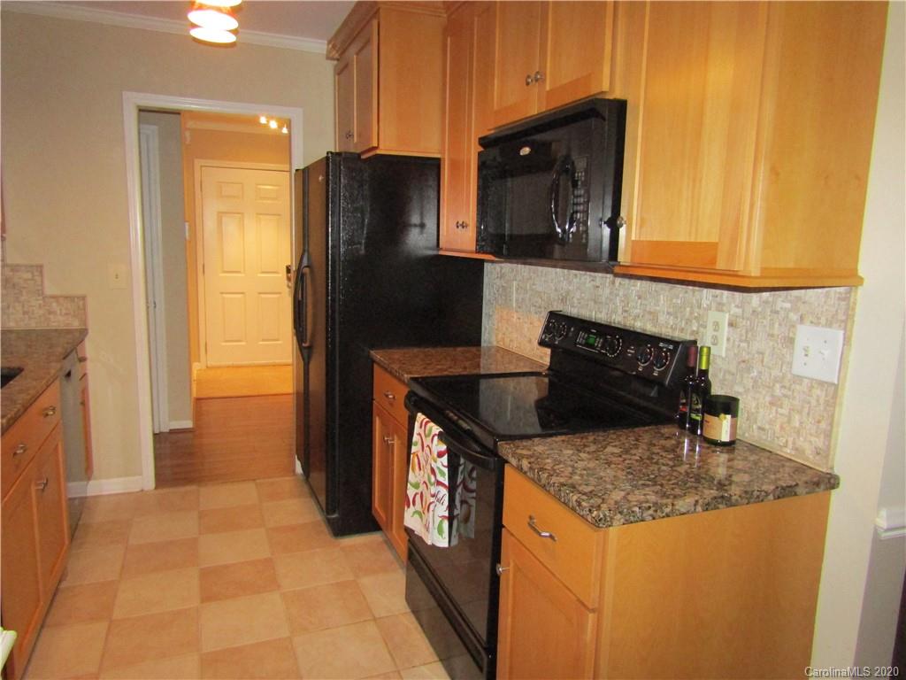 12820 Danby Road Indian Land, SC 29707 - Photo 7 of 21 a kitchen with granite countertop a refrigerator a stove and a sink