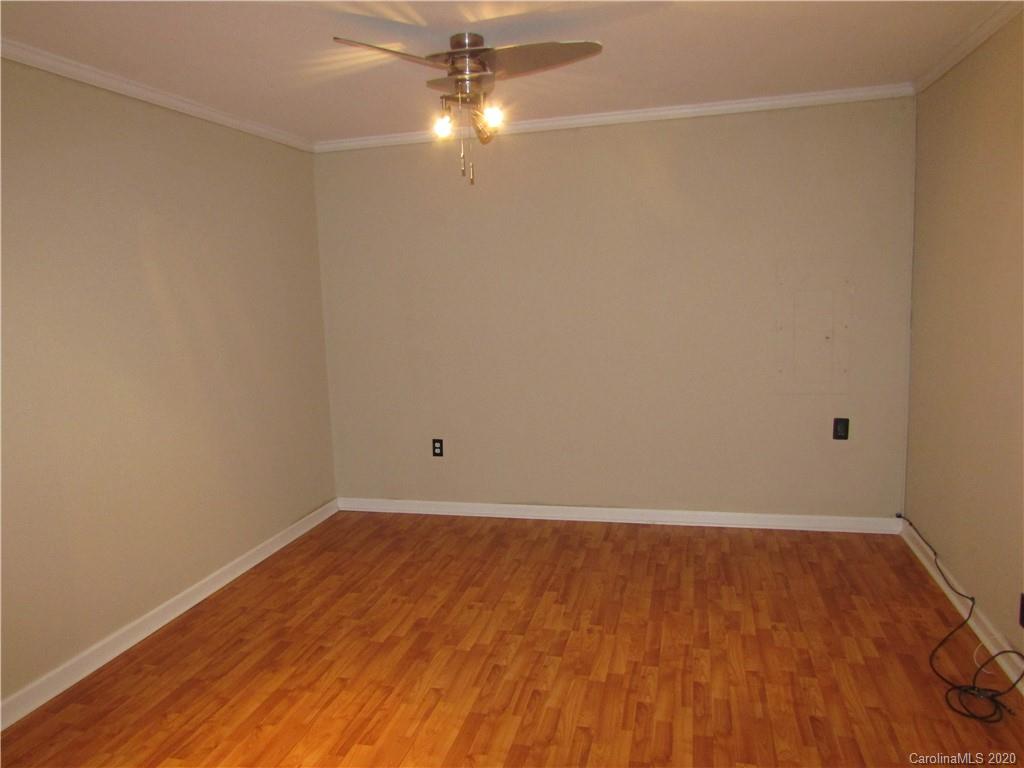 12820 Danby Road Indian Land, SC 29707 - Photo 9 of 21 an empty room with wooden floor and fan