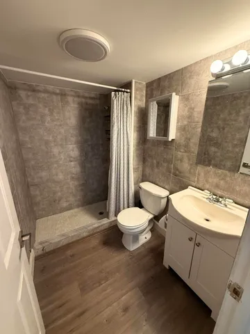 a bathroom with a toilet sink and shower