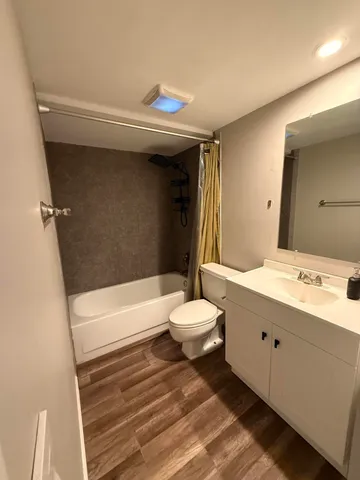 a bathroom with a sink a toilet and bathtub