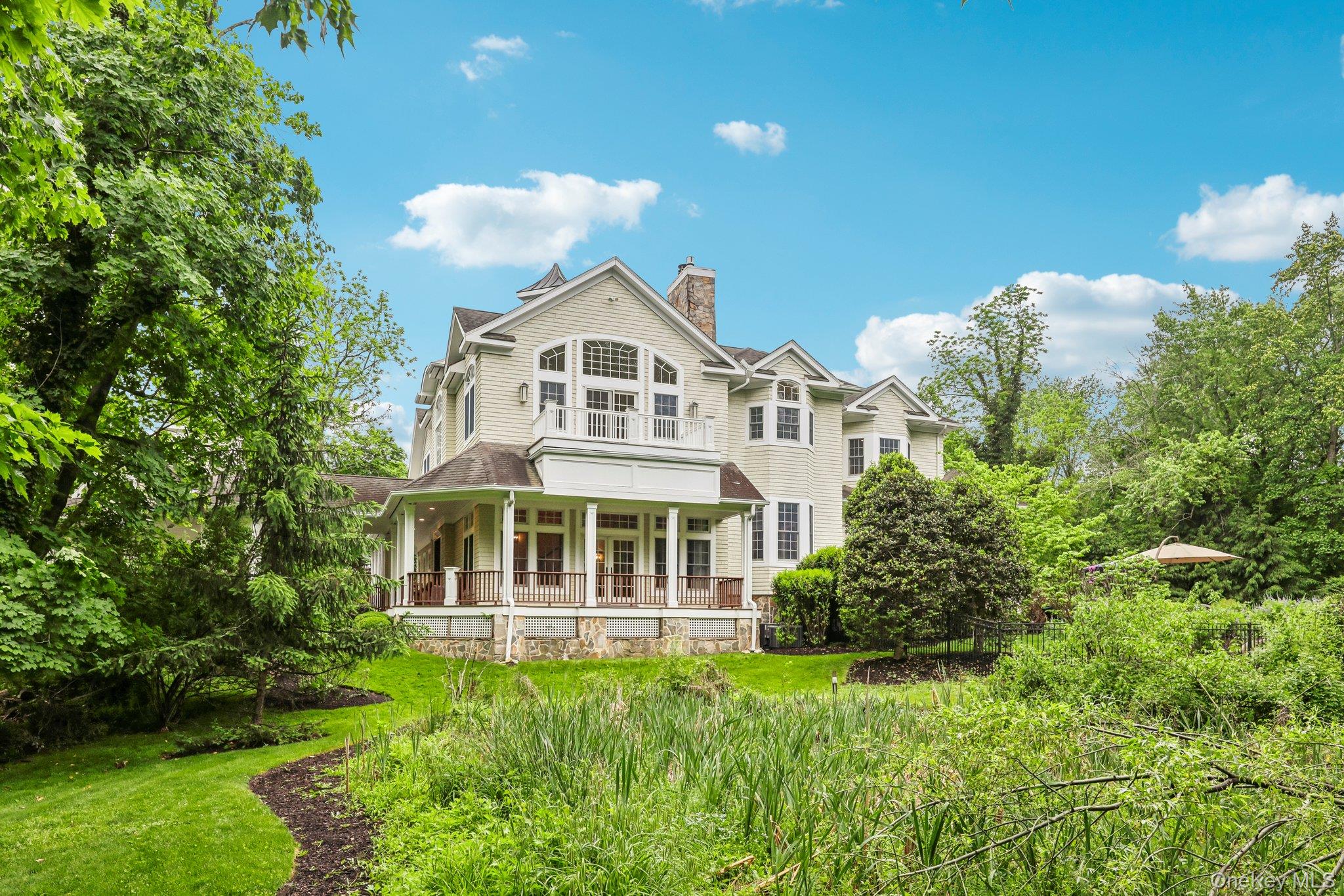 5 Mill Road Lloyd Harbor, NY 11743 - Photo 45 of 49 a front view of a house with a yard