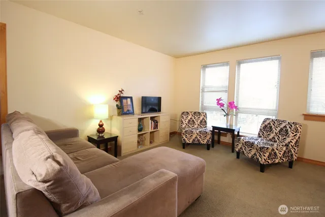 a bedroom with furniture and a large window