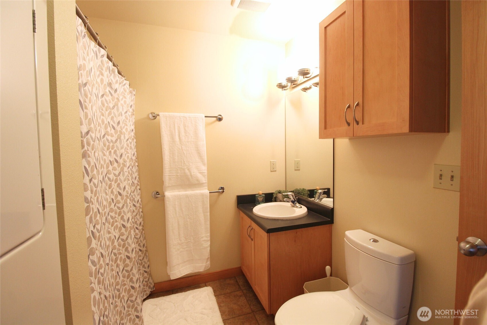 827 Hiawatha Place South, Unit 406 Seattle, WA 98144 - Photo 6 of 13 a bathroom with a sink toilet and shower