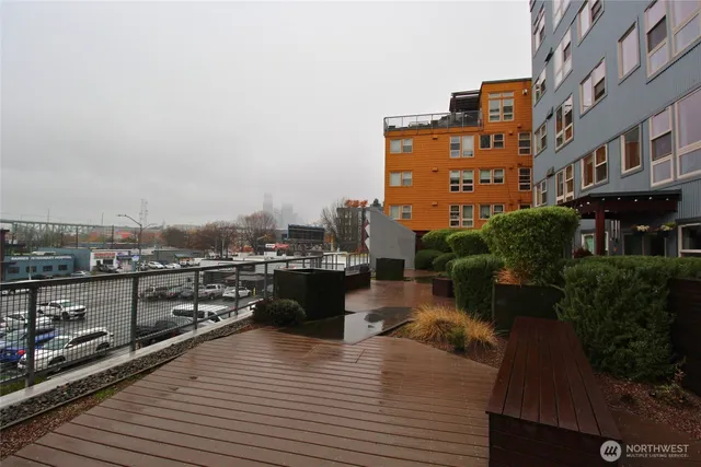 a view of a roof deck with couches and wooden floor