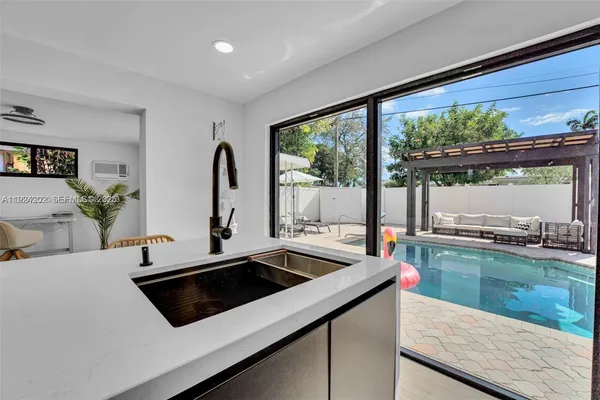 a kitchen with a sink and a large window