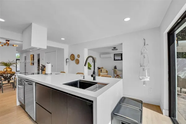 a kitchen with stainless steel appliances a sink a refrigerator and a stove