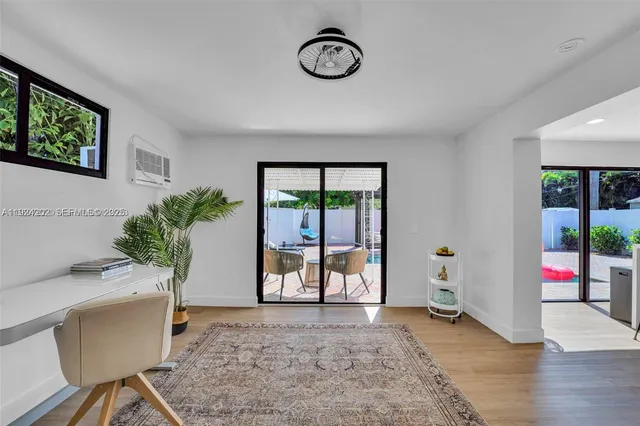 a view of an entryway with wooden floor
