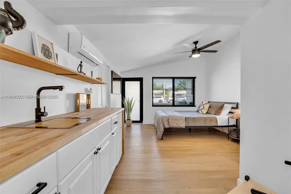 a spacious bedroom with a bed and a couch