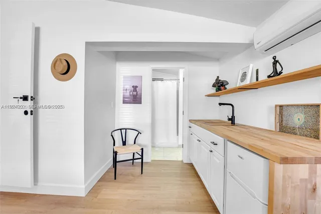 a spacious bathroom with a granite countertop sink and a mirror