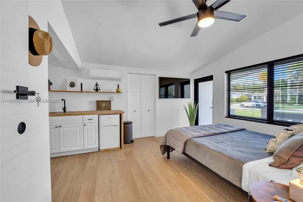 a bedroom with a bed and a chandelier