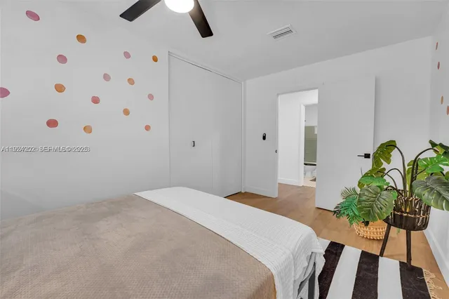 a bedroom with a bed and a potted plant