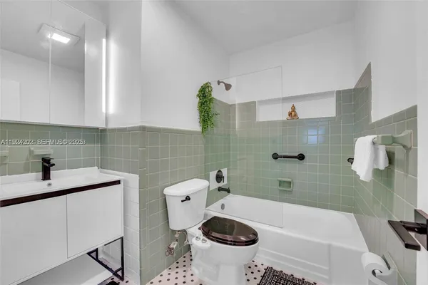 a bathroom with a sink a toilet and bathtub