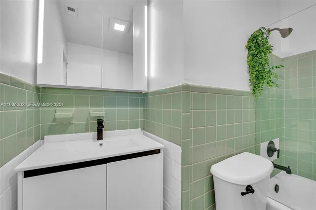 a bathroom with a sink a toilet and a mirror