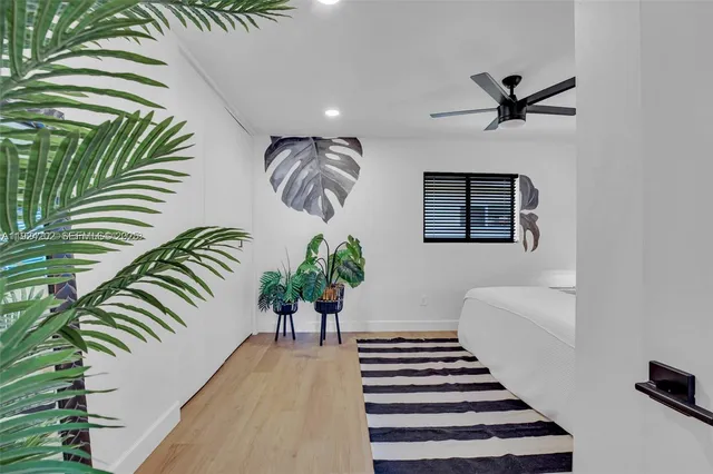 a view of a hallway with wooden floor and a chandelier