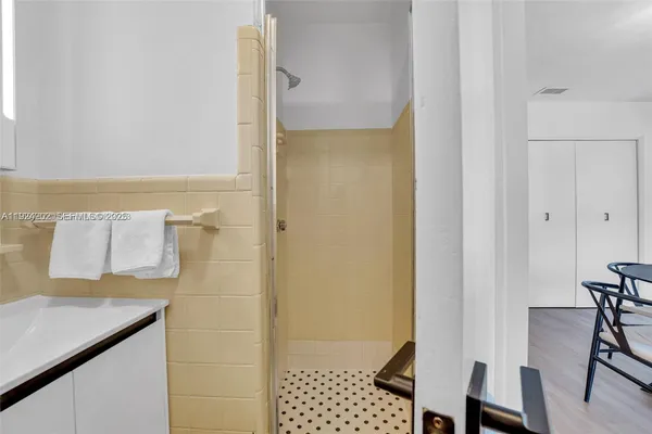 a bathroom with a shower and a sink