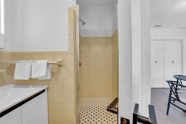 a bathroom with a shower and a sink