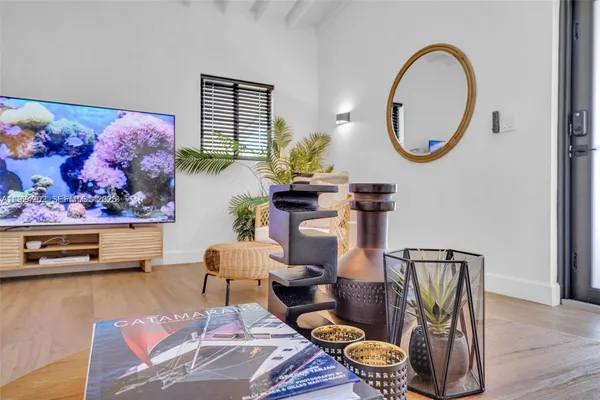 a living room with furniture and a mirror